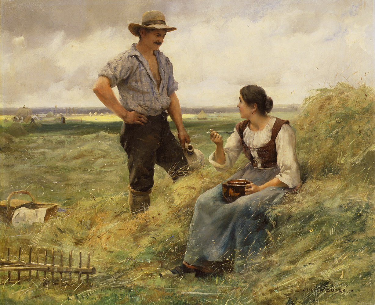 man and woman eating in the field
