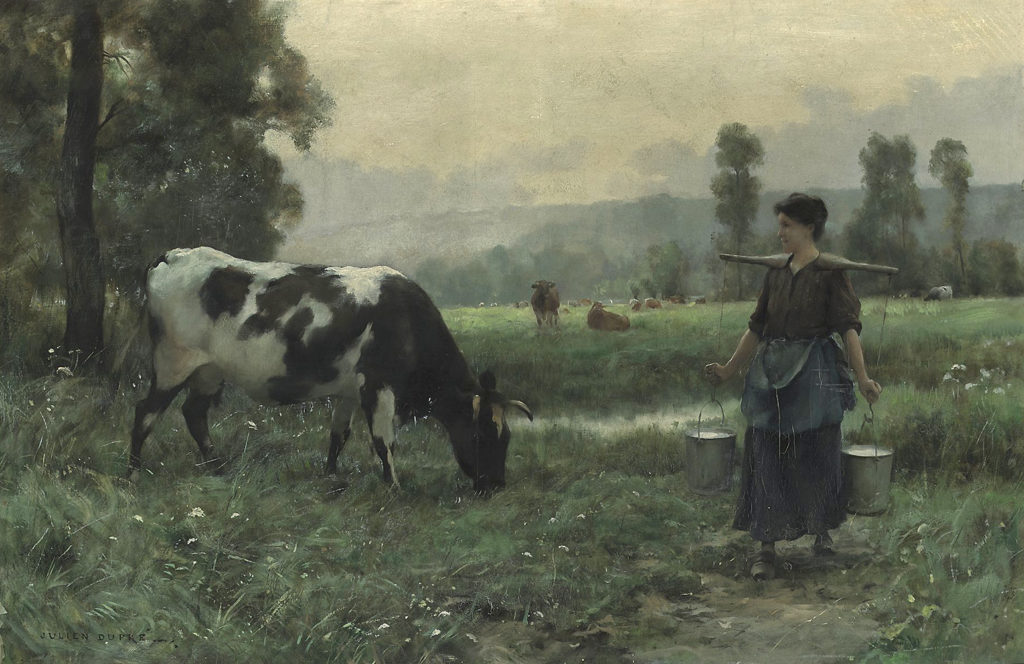 woman with cows in a landscape