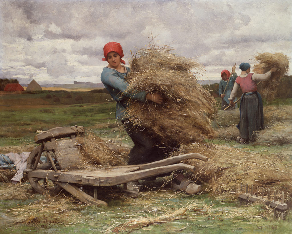 three women gathering hay