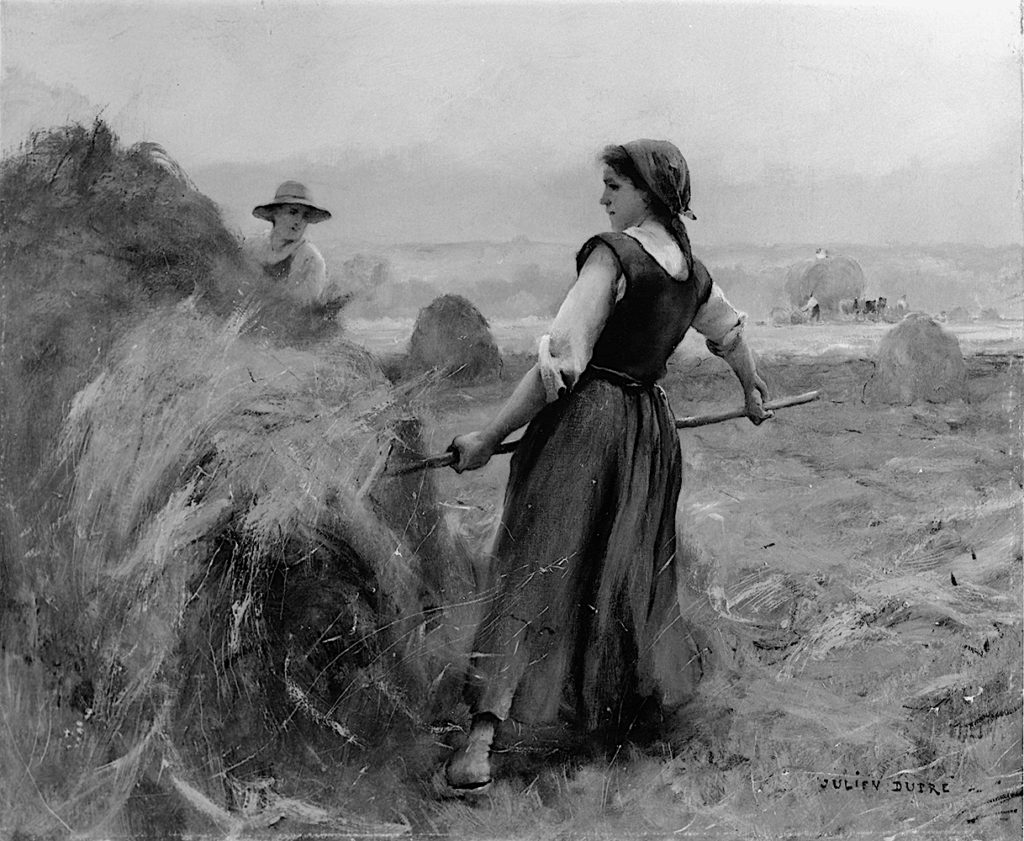 woman pitching hay