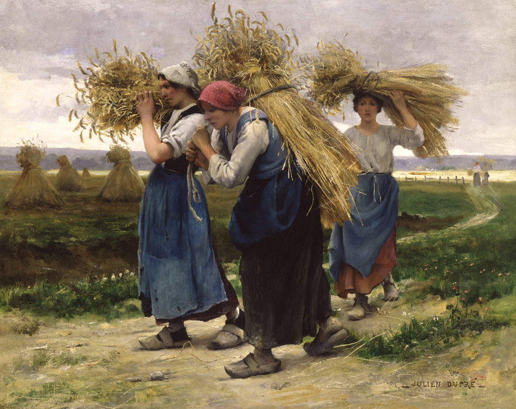 three woman carrying wheat