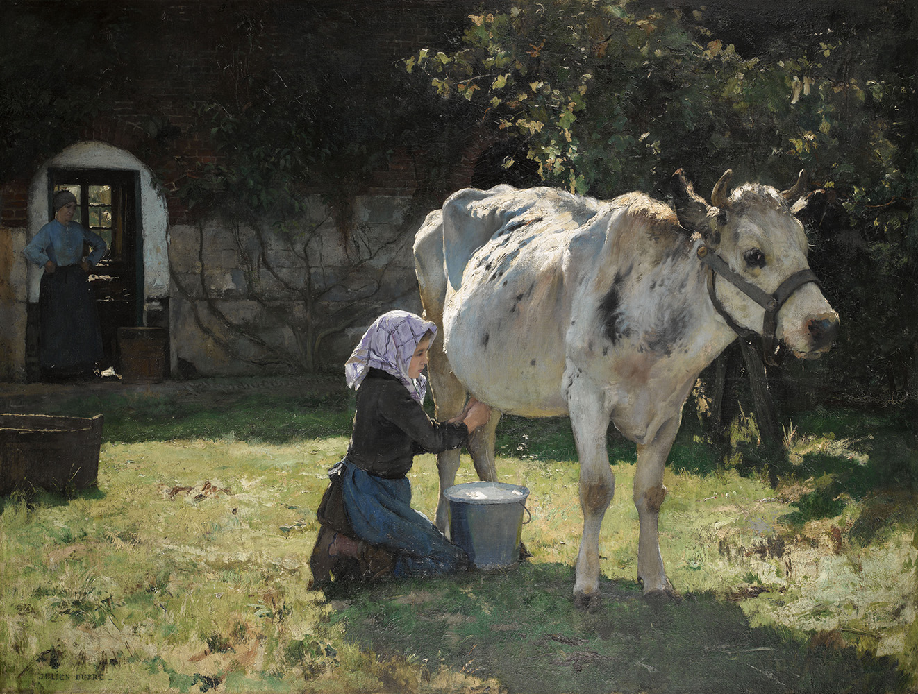 young girl milking a cow